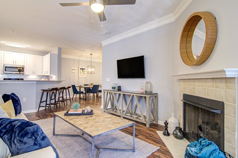 a living room with a fireplace and a table with chairs